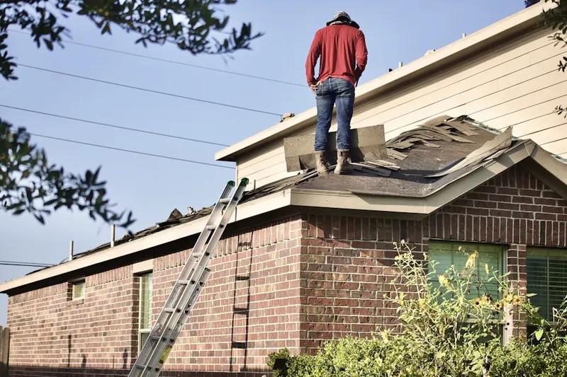 Professional roofer working on a residential roof in Long Lane Acres